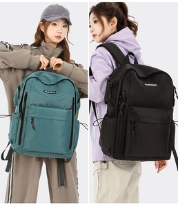 Detail view of large capacity nylon travel backpacks in dark green and black colors