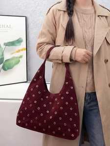 Large burgundy suede hobo shoulder bag with stylish gold eyelet studs and wide strap