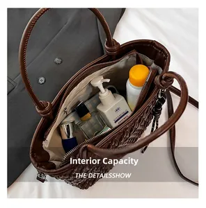 Detail view of spacious interior capacity in deep brown woven tote bag with zip pocket