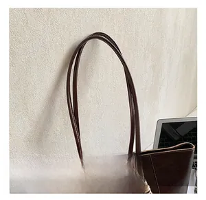 Detail shot of the comfortable thin double handles on the brown oil wax tote bag