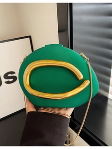 Elegant green acrylic box clutch with gold C-handle and delicate gold chain strap
