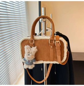 Détail du sac carré mat marron avec bordure en peluche blanche et porte-clés ours