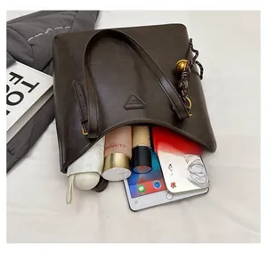 Top view showing a large capacity coffee tote bag filled with daily items on white fabric