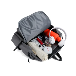 Top view of open travel backpack showing spacious interior with tablet and accessories