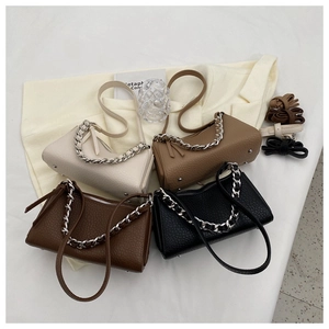 Detail of four shoulder bags with litchi texture, metal chains and bottom protective studs