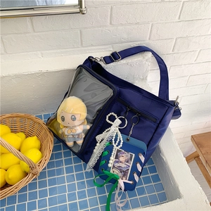 Dettaglio della borsa Ita blu scuro con finestra trasparente, peluche anime e ciondoli decorativi