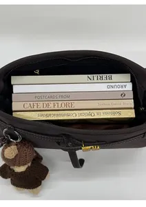 Top view of spacious brown tote bag interior showing capacity for multiple books