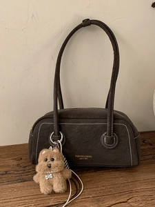 Retro dark brown underarm bag with contrast stitching and a cute plush dog pendant