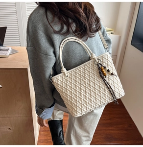Quilted beige bucket bag with wooden beads showing stylish daily commuting outfit details