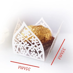 Close-up of white laser-cut hollow paper chocolate holder with 35mm size markings