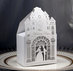 Macro detail of laser-cut wedding candy box with castle pattern and Wedding Day text