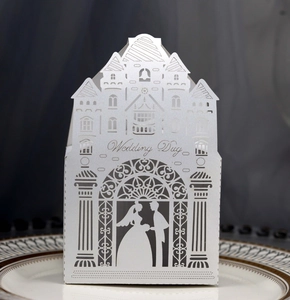 Detailed laser-cut white pearl paper wedding candy box with elegant castle silhouette