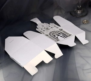 Flat laser-cut pearl paper wedding candy box with castle and couple silhouette detail
