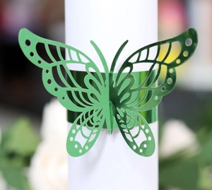 Elegant emerald green laser-cut butterfly napkin ring with a reflective mirror finish