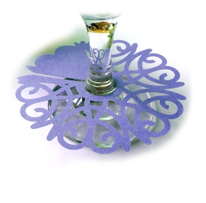 Purple laser-cut paper wine glass place cards with intricate hollowed floral patterns