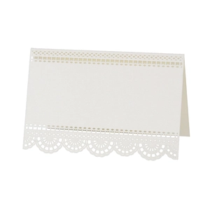 Détail de la dentelle découpée au laser et du motif ajouré sur le marque-place beige