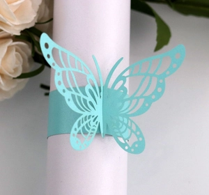 Close-up of laser-cut light blue butterfly paper napkin ring with a pearlescent finish