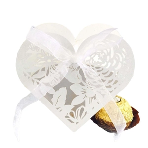 White laser cut heart shaped wedding favor box with floral patterns and silk ribbon