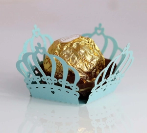 Detail of laser-cut crown paper chocolate lace holder in Tiffany blue for wedding favors