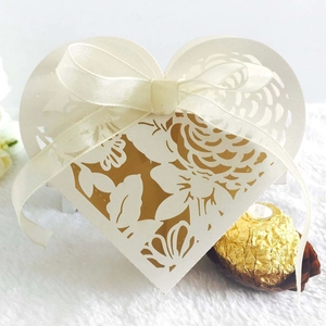 Detailed laser-cut heart favor box with floral patterns and a cream silk ribbon bow
