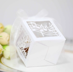 Detailed laser-cut music note patterns on premium white paper candy box with ribbon