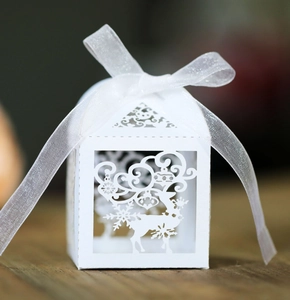 Detailed laser-cut Christmas reindeer paper gift box with white organza ribbon bow