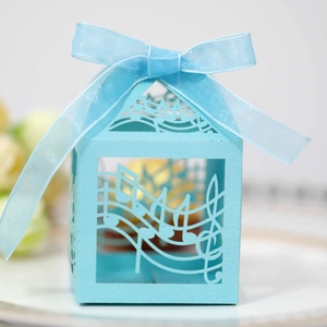 Light blue laser-cut candy box with musical notes pattern and a silk ribbon bow