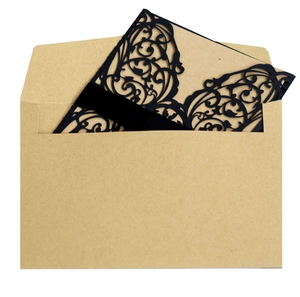 Intricate laser-cut black wedding invitation with kraft envelope and silk ribbon detail