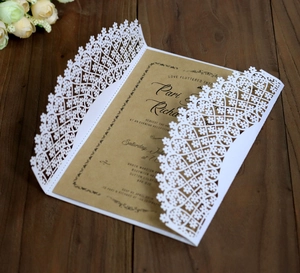 Elegant laser-cut floral white wedding invitation with rustic kraft paper insert card