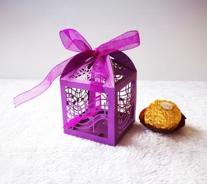 Detailed view of purple laser-cut music note candy box with elegant ribbon and pearl finish