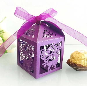 Close-up of laser-cut reindeer and snowflake patterns on a purple Christmas gift box