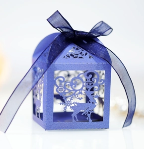 Light blue laser-cut reindeer candy box with snowflake patterns and dark blue silk ribbon