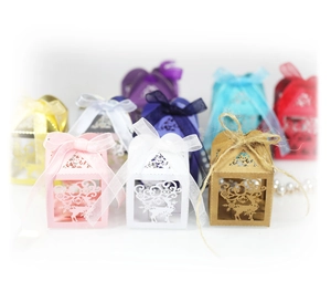 Laser-cut reindeer Christmas favor boxes in assorted colors with festive ribbons
