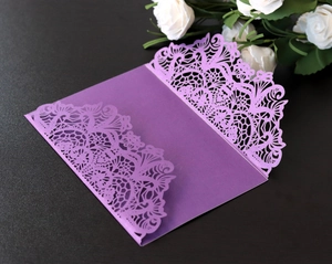 Elegant laser-cut dark purple invitation cover with intricate floral lace for weddings