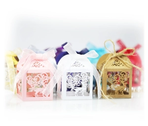 Close-up of laser-cut gift boxes with reindeer and snowflake patterns in various colors