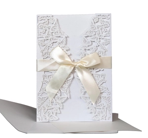 Elegant white laser-cut wedding invitation featuring butterfly design and cream silk bow