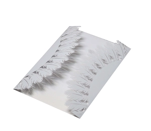 Close-up of laser-cut white wedding invitation featuring intricate feather paper patterns