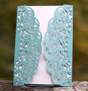 Elegant laser-cut light blue wedding invitation featuring floral hollow lace patterns