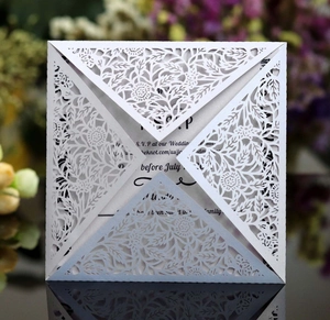 White laser cut wedding invitation with elegant floral lace patterns and RSVP insert