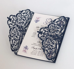 Detailed view of navy blue laser-cut lace wedding invitation with elegant floral patterns
