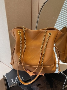 Vintage brown quilted leather bucket bag with gold chain strap for women commuters