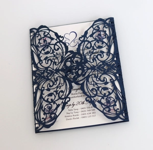 Detail of laser-cut navy blue butterfly invitation card with white printed insert