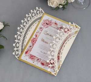 Elegant ivory laser cut wedding invitation with golden border and red floral pattern