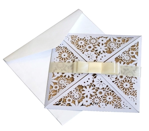 Laser cut floral wedding invitation set with white envelope and beige ribbon bow