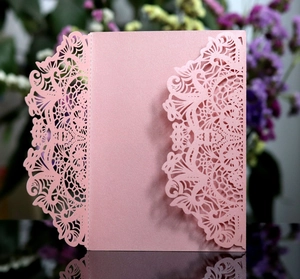 Detail of pink pearlescent laser cut lace floral invitation cover for weddings
