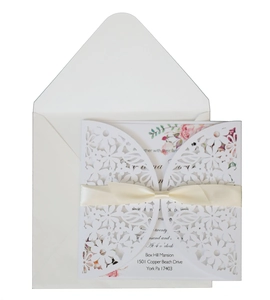 Elegant laser cut white floral wedding invitation with cream satin ribbon and pink floral inner