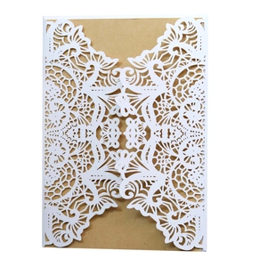 Detailed laser-cut white lace floral pattern on elegant kraft paper wedding invitation