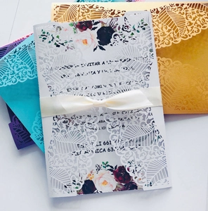Detailed laser cut wedding invitation set with cream silk ribbon and vintage floral inner card