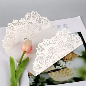 Detailed laser-cut ivory floral invitation cover with elegant lace pattern and tulip decor