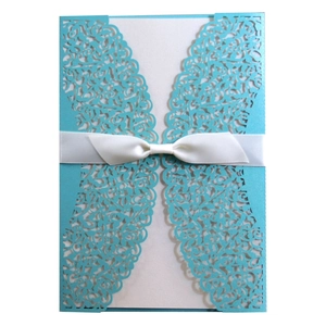 Elegant laser cut blue wedding invitation card with a white satin ribbon bow